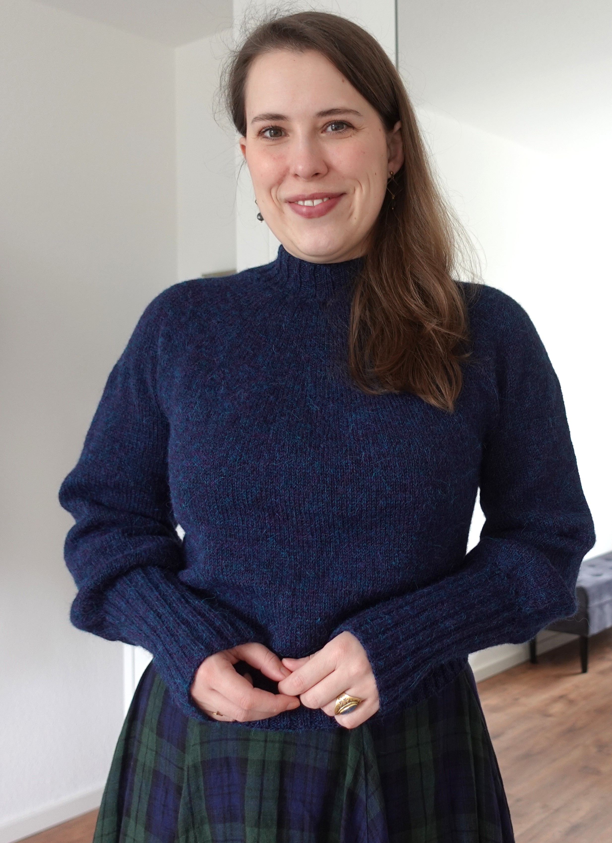 A circular yoke sweater with a fitted neckline, volumnous sleeves and long ribbed cuffs.